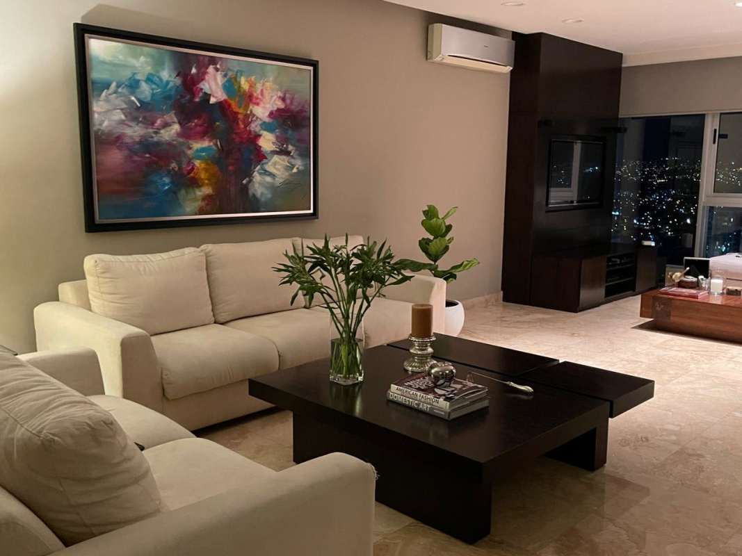 Living room with corner windows, city night view, TV wall in Costa del Este Panama