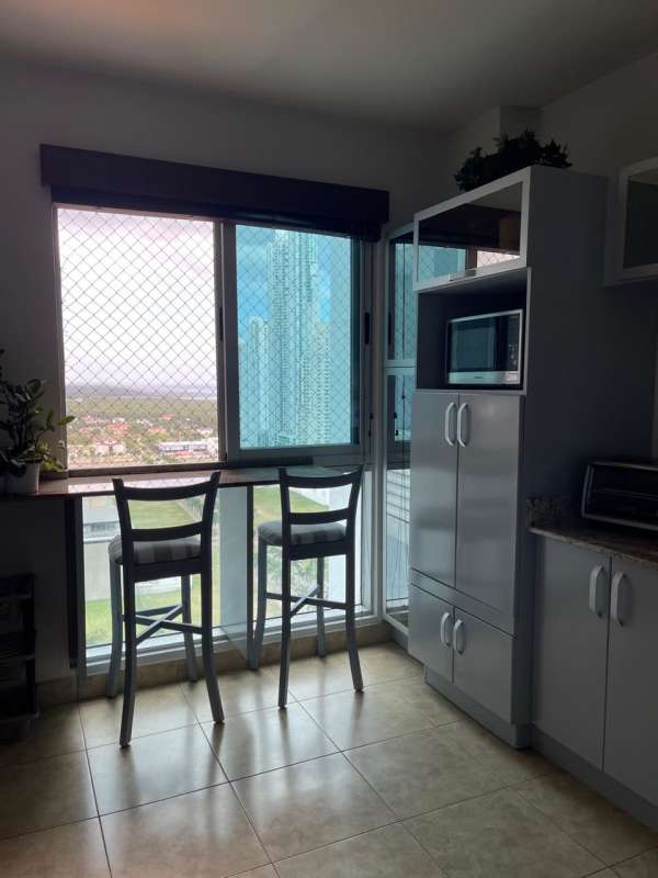 Modern kitchen with granite counters, tile backsplash, appliances in PH Titanium Costa del Este Panama