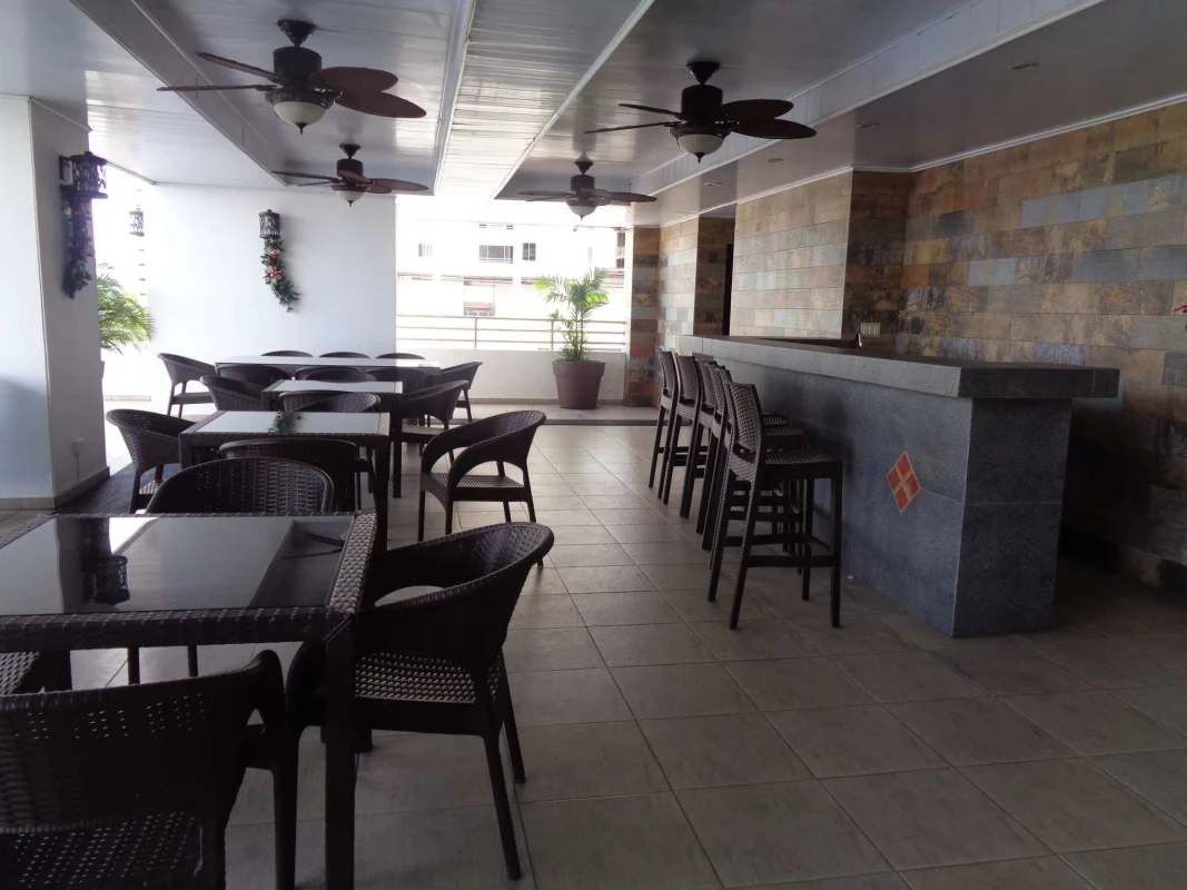 Bright contemporary bathroom with walk-in shower, white vanity and decorative tile border in PH Hato Pintado