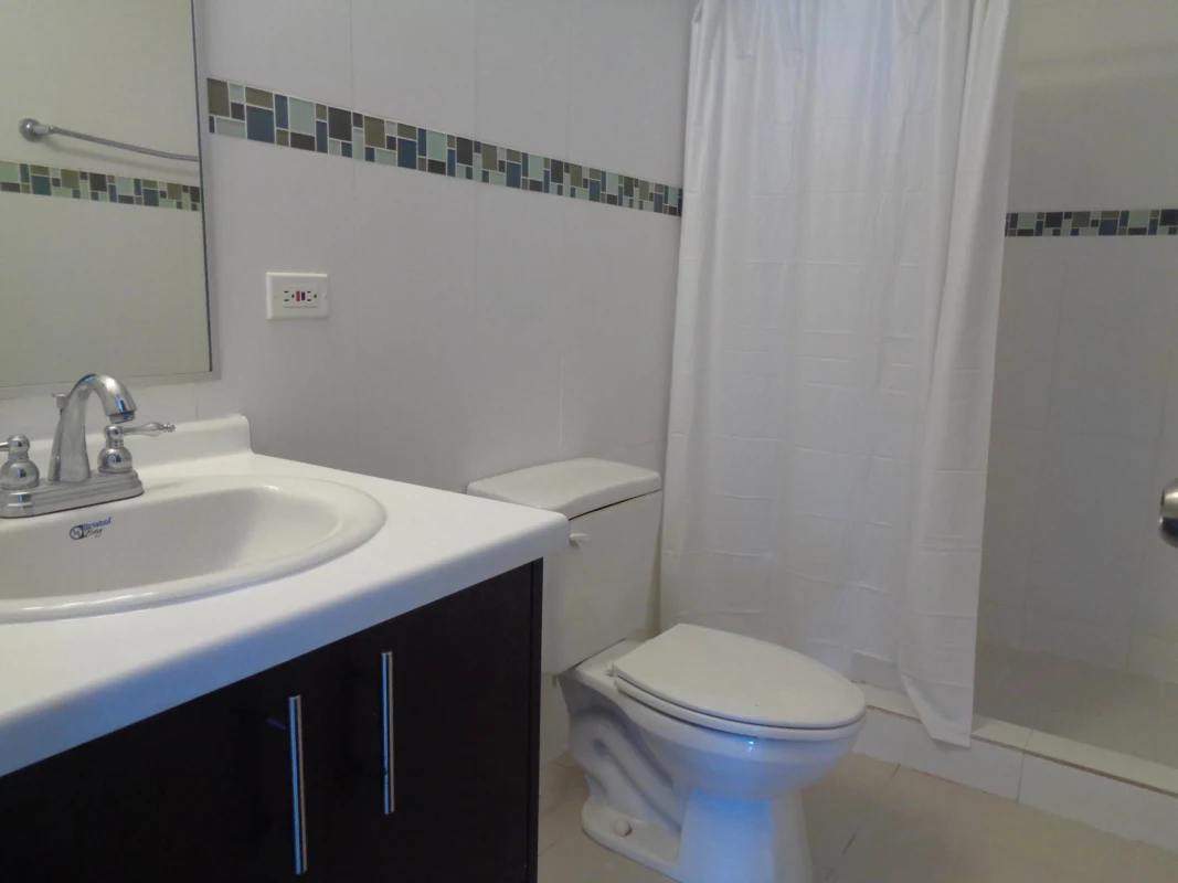 Open-plan living and dining area with large windows showing panoramic Panama City night view in PH Hato Pintado Tower