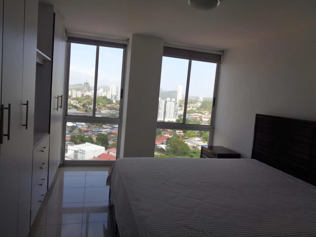 Bright bedroom with large windows and skyline city view in PH Hato Pintado Tower