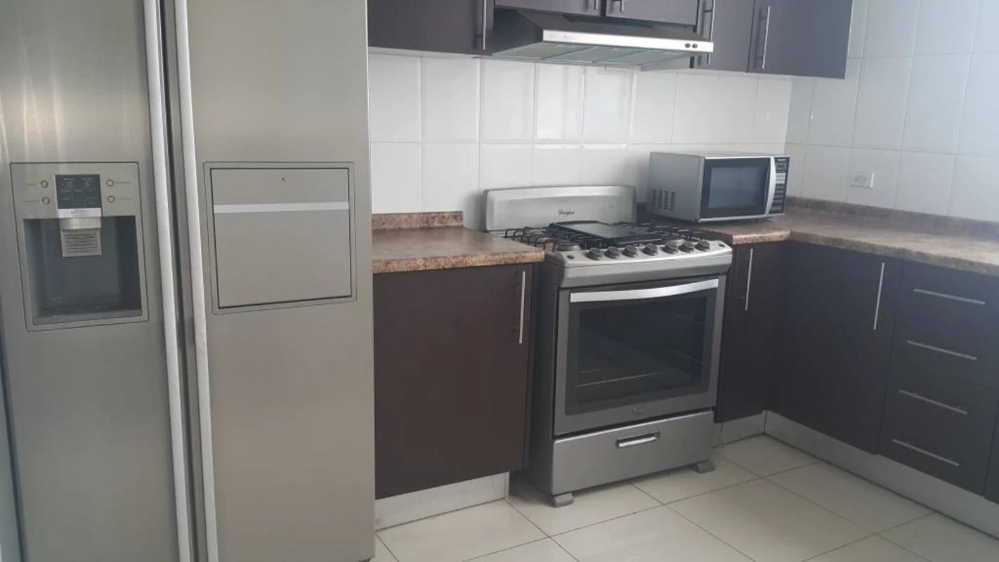 Kitchen with stainless steel appliances, brown cabinetry and granite-style countertops in PH Hato Pintado