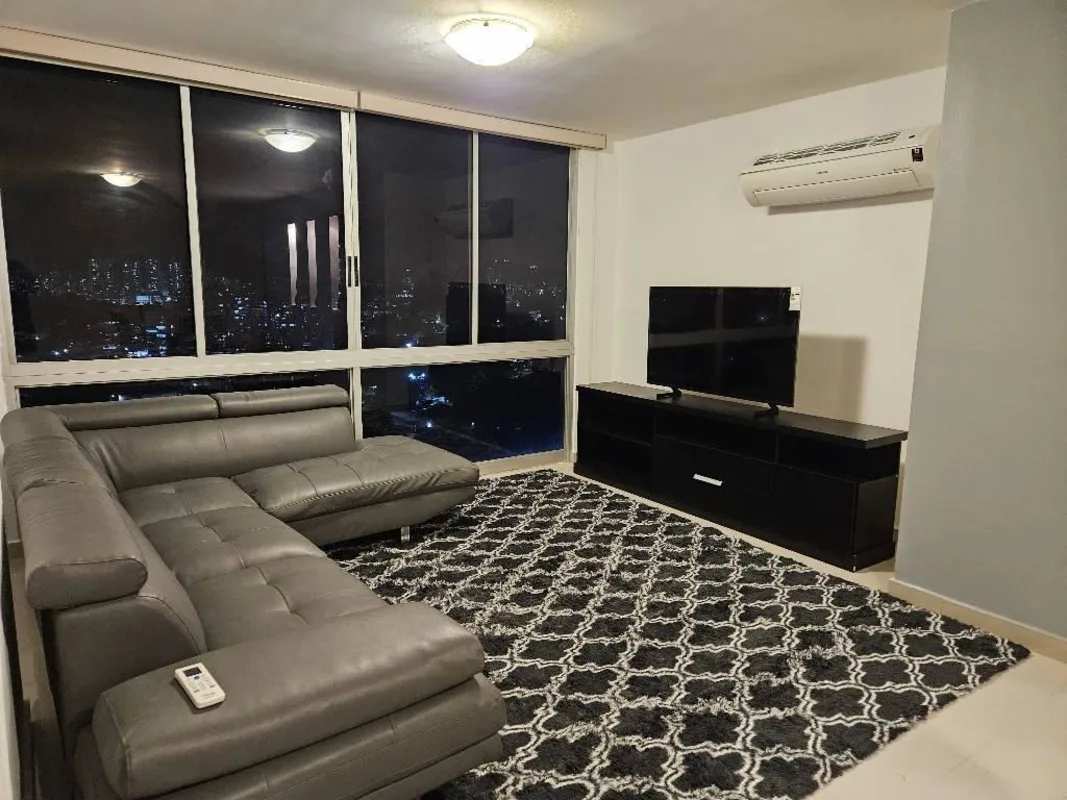 Outdoor covered lounge terrace with wicker furniture and bar counter in PH Hato Pintado Tower