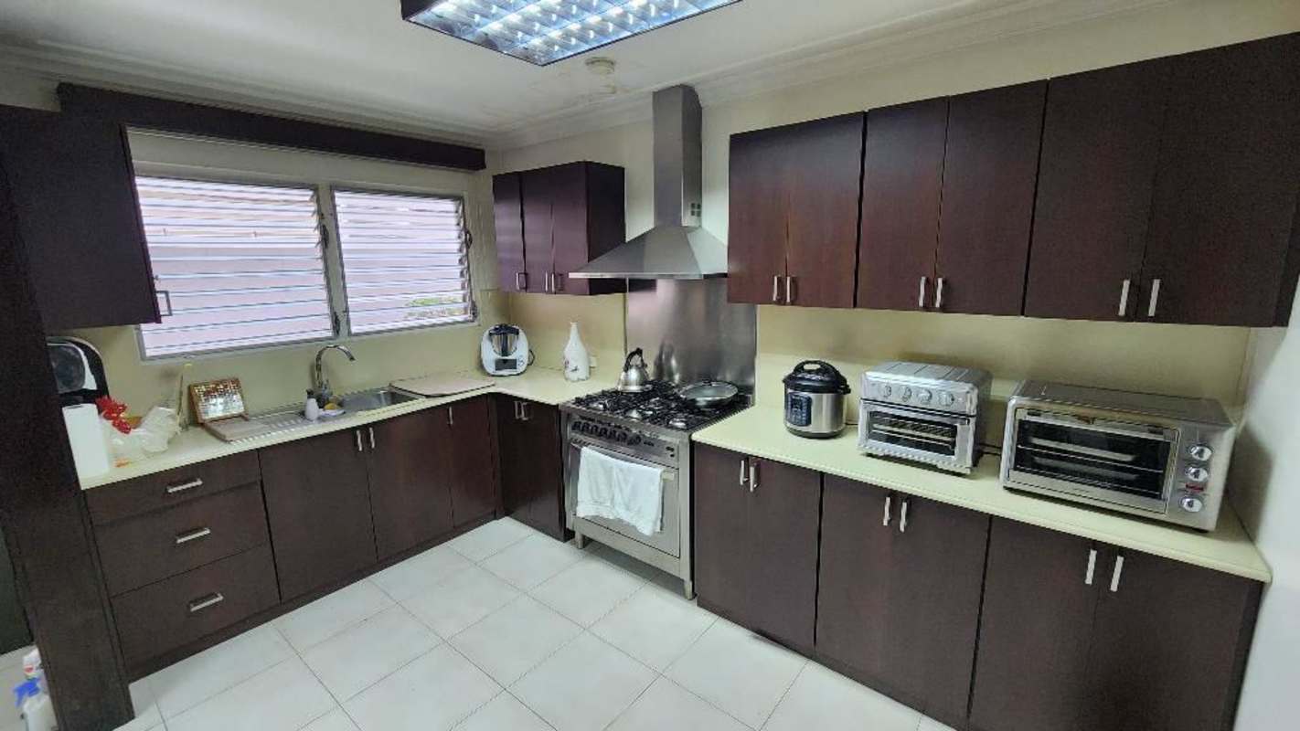 Dining area with wooden accents, sliding glass doors, tiled floor at Betania Panama