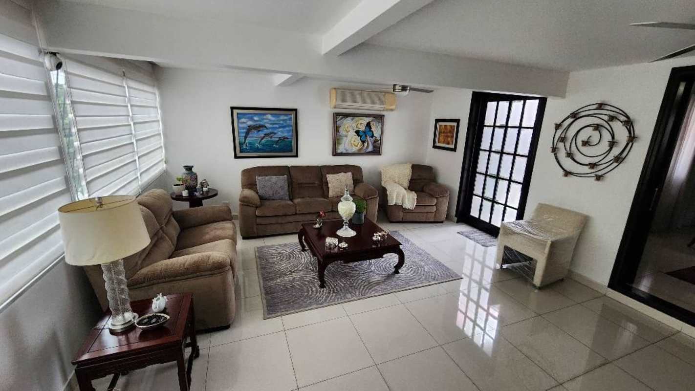 Bathroom with pedestal sink, tiled walls, frosted glass shower enclosure in Betania Panama