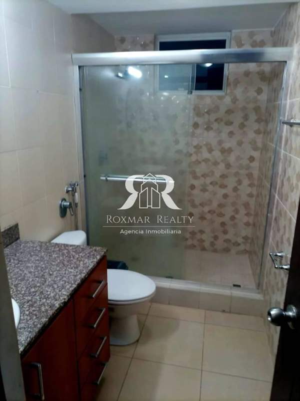 Bathroom with glass-enclosed shower, granite countertop in PH Blue Park Panama City