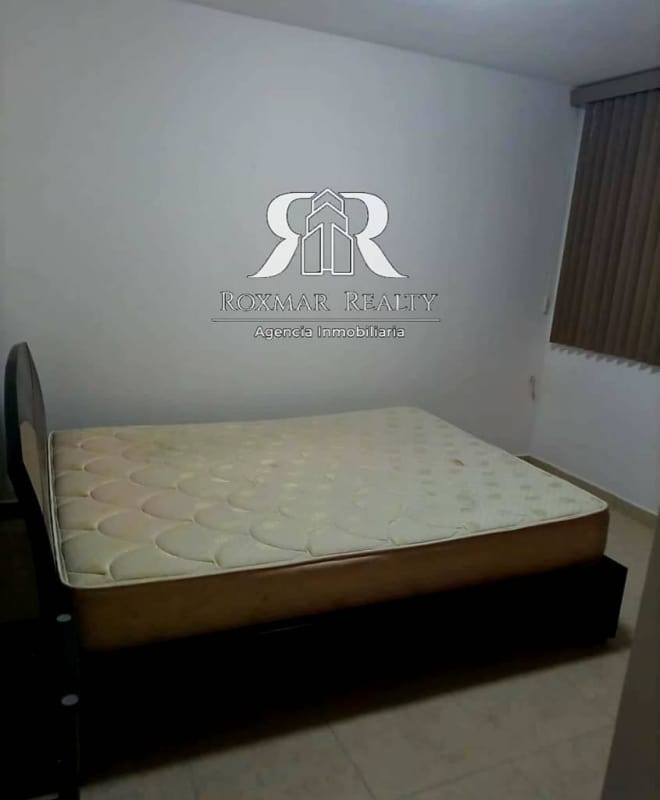 Simple bedroom with bed, window and blinds in PH Blue Park Panama City