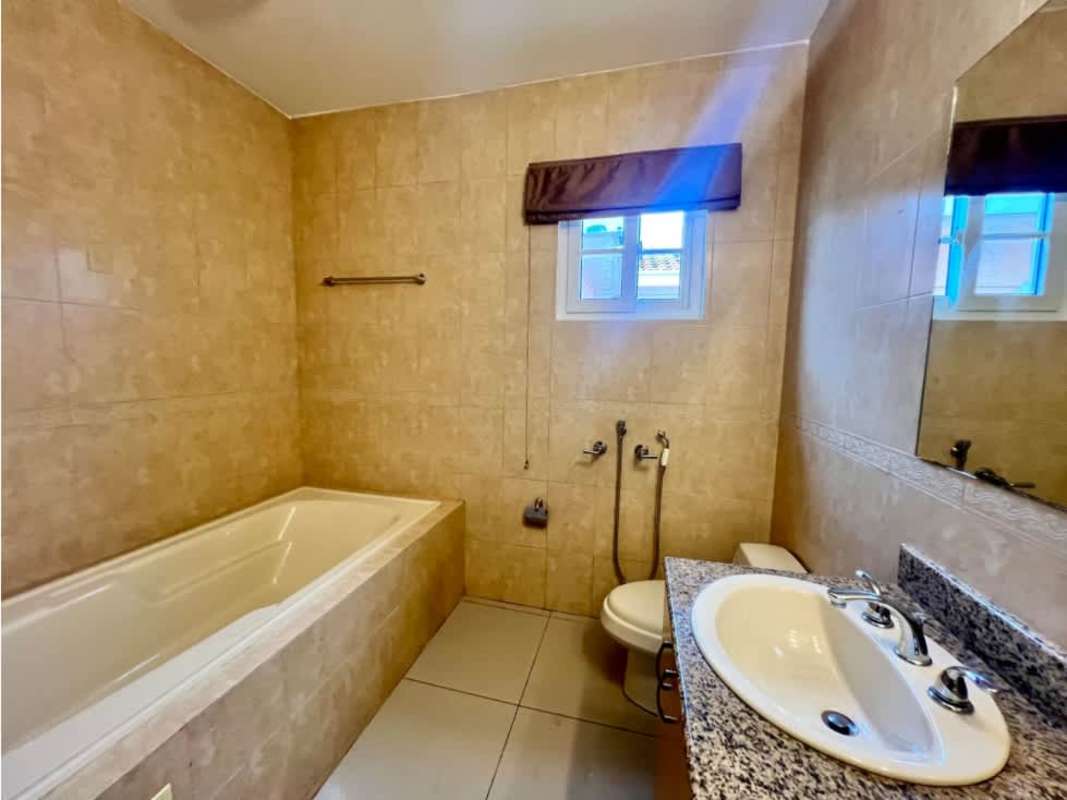 Outdoor pool with landscaped garden and decorative bridge in Villa Valencia Costa Sur Panama City