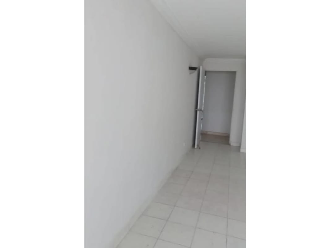 Spacious modern kitchen with white cabinets black countertops built-in double oven gas cooktop in PH Tamanaco Punta Paitilla Panama City