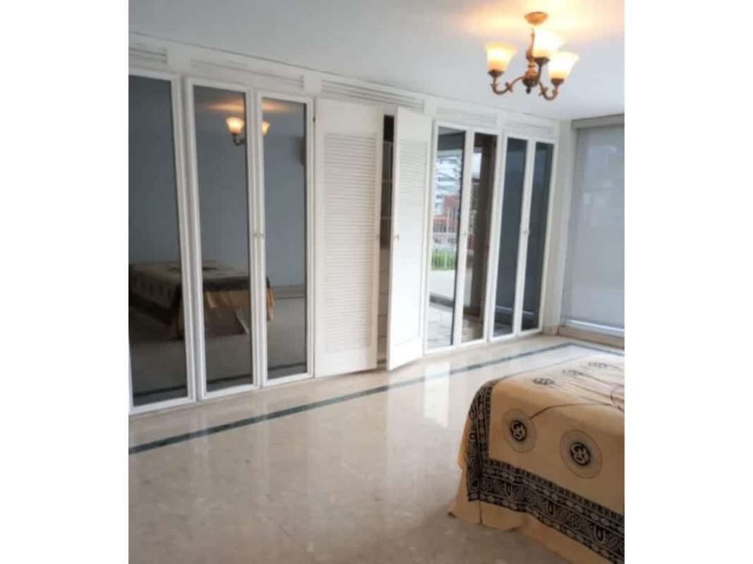 Minimalist hallway with white walls marble floors at PH Tamanaco Punta Paitilla luxury apartment