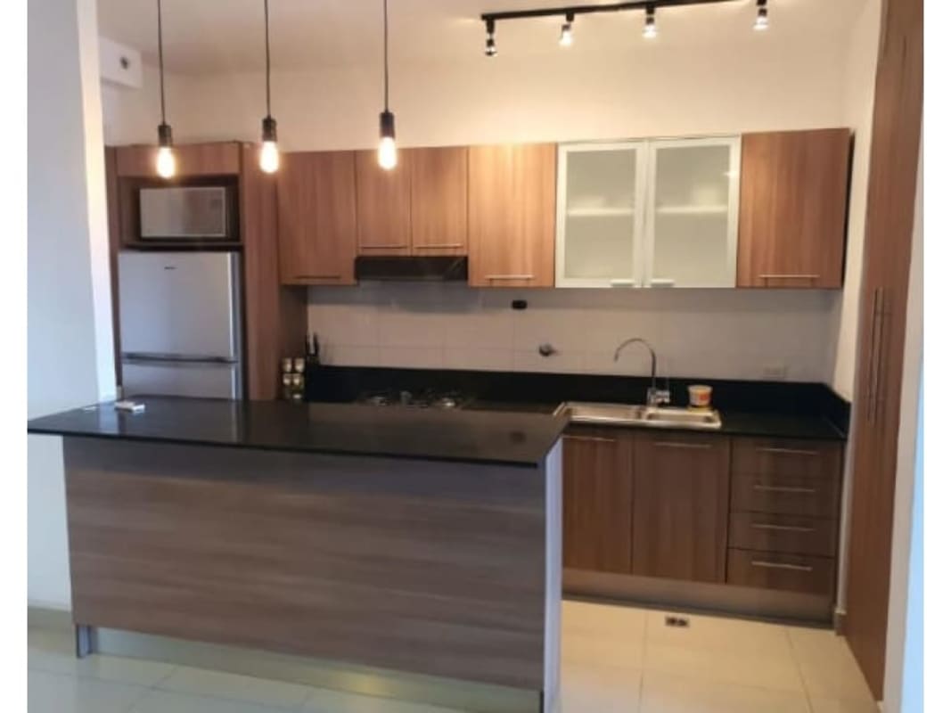 Contemporary kitchen with wood cabinets, granite countertop, appliances in PH Diamond Tower San Francisco Panama