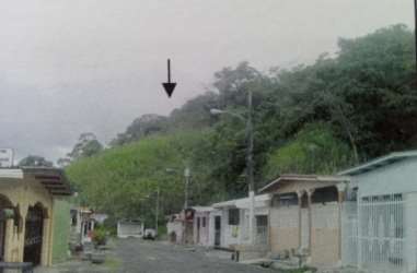 Street view with houses, hills and green backdrop near development lot Cativá Colón Panama