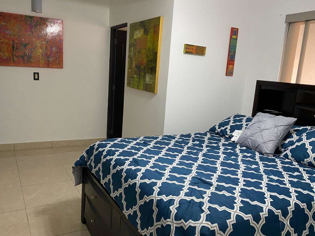 Stylish dining room with textured wall and large glass table in Residencial Versalles Panama City