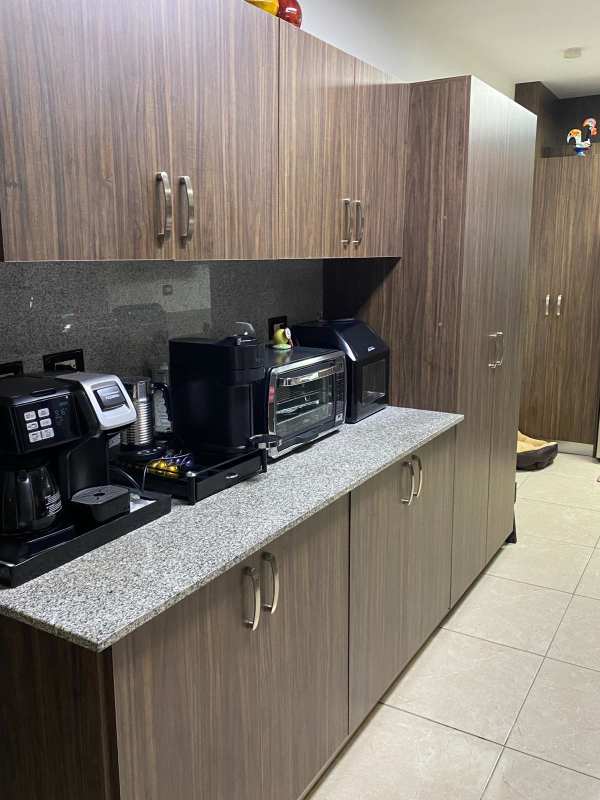 Modern granite kitchen with appliances and wood cabinetry in gated Residencial Versalles Panama