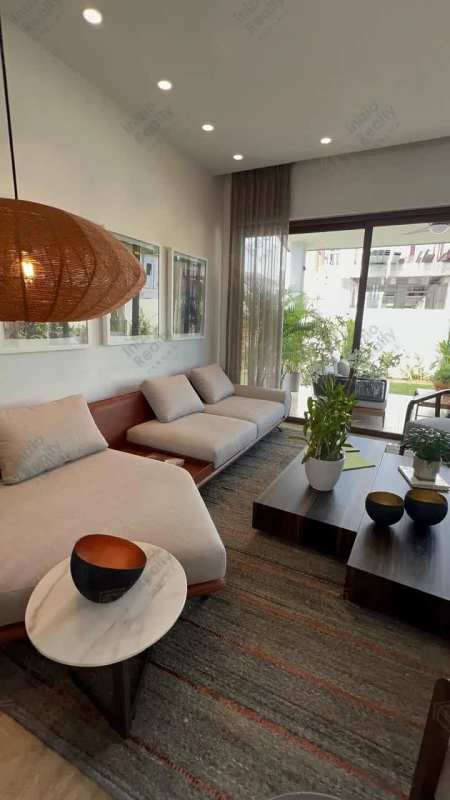 Open plan living and dining with large windows at The Woods Santa María Golf & Country Club