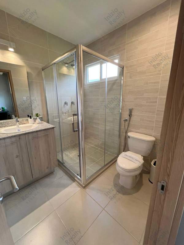 Elegant bedroom with wood accent and built-in storage in townhouse Brisas del Golf Panama City