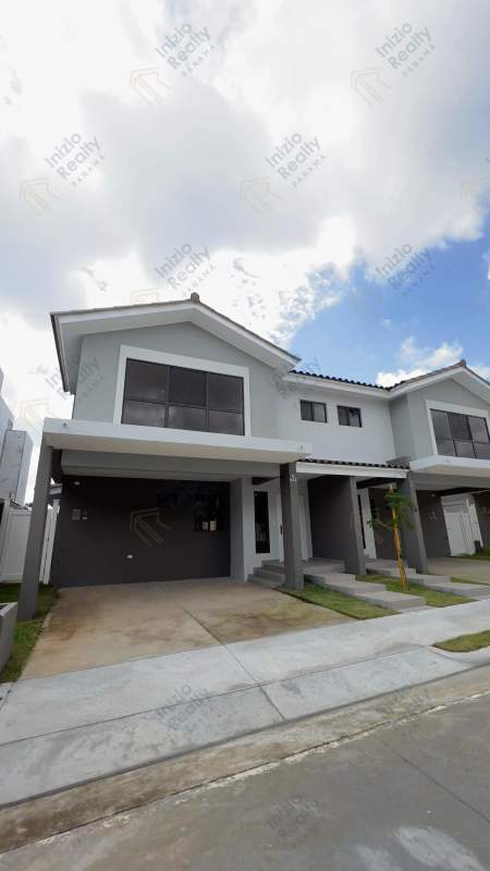 Two-story modern townhouse with carport and large windows in Paseo del Norte community Panama City