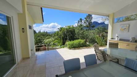 Covered balcony patio overlooking green valley and Picacho Mountain in Altos del María Panama