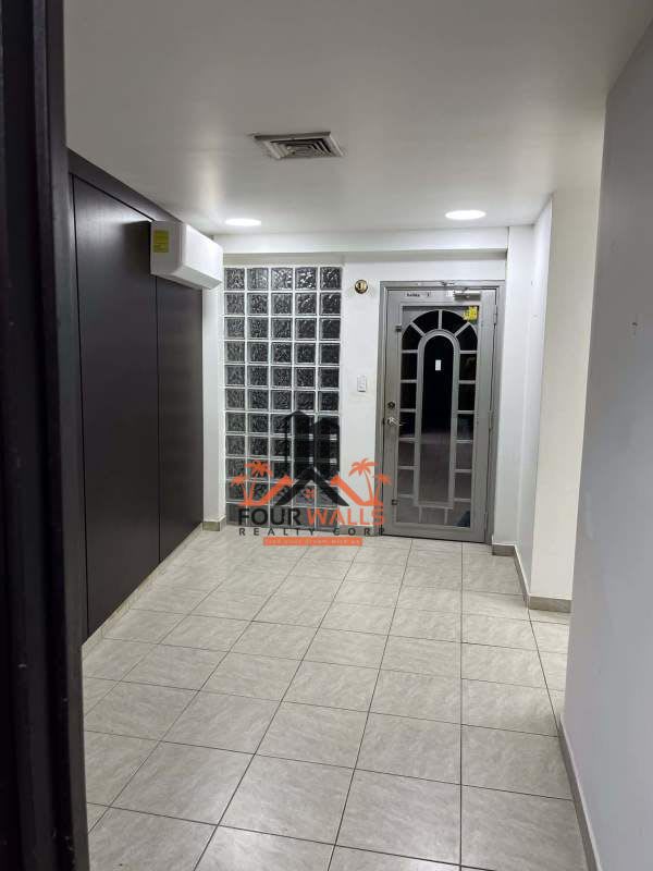 Entryway with metal door, glass block wall Business Plaza San Francisco Panama