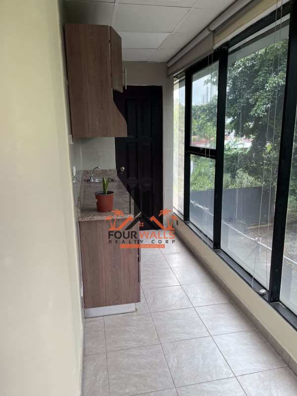 Narrow utility room with cabinets, granite counter, large windows office Panama