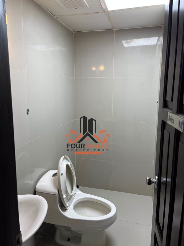 Office room with desks, windows open to greenery commercial space Panama