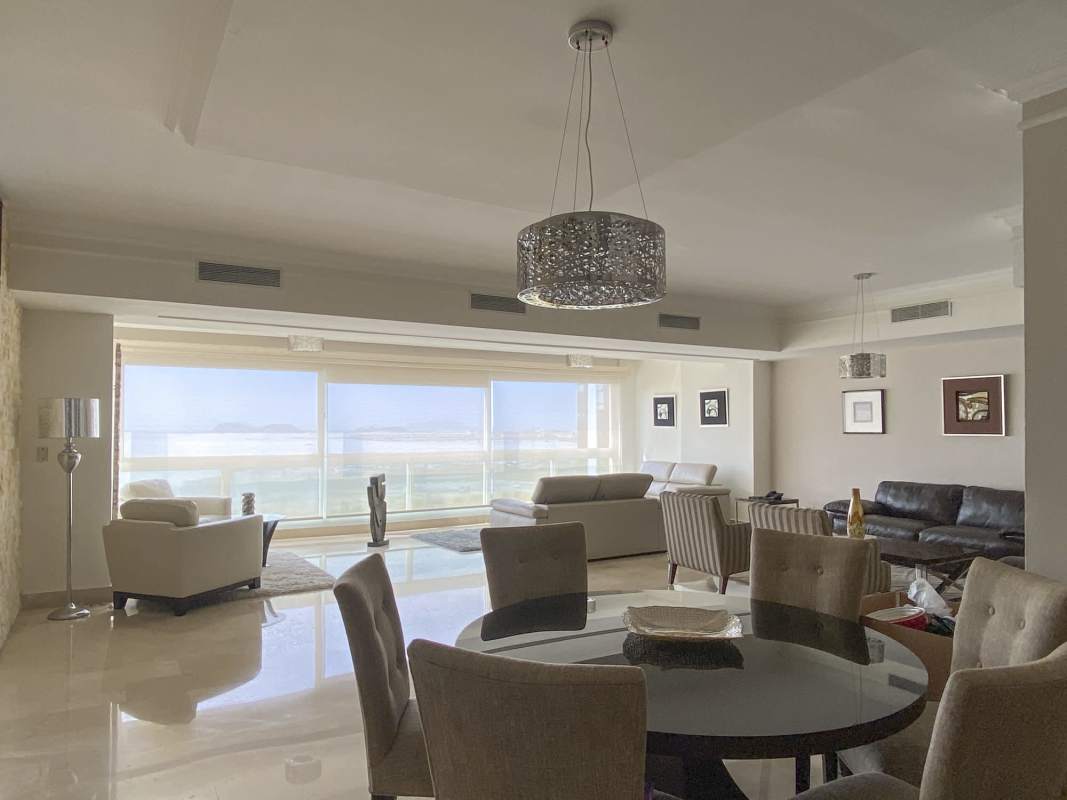 Contemporary open living dining space floor-to-ceiling glass panoramic ocean views PH BICSA Tower Panama