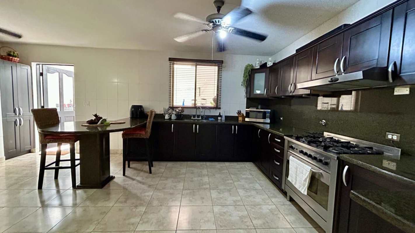 Contemporary kitchen with granite countertops and wood cabinets in Paseo Dorado Condado del Rey Panama