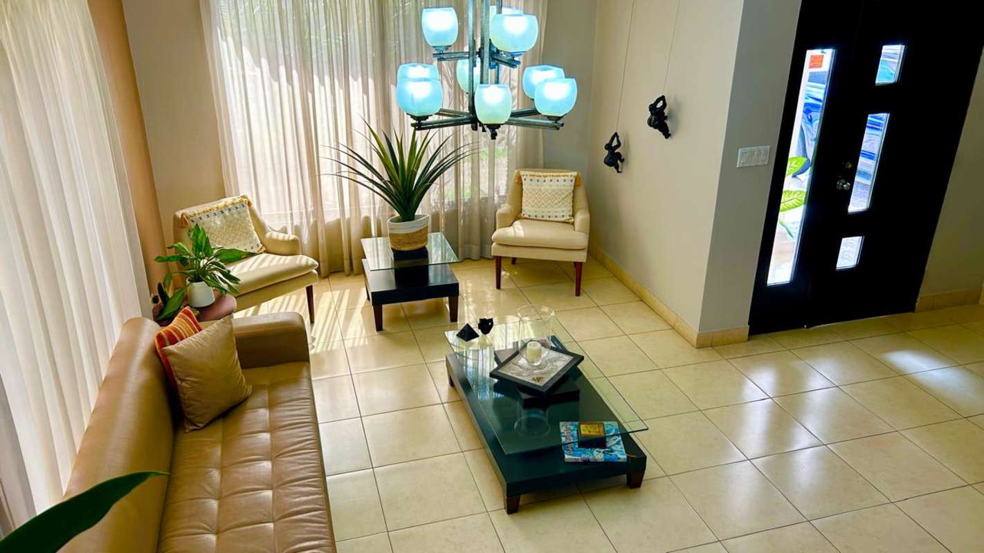 Spacious living room with large windows and chandelier in Condado del Rey Panama
