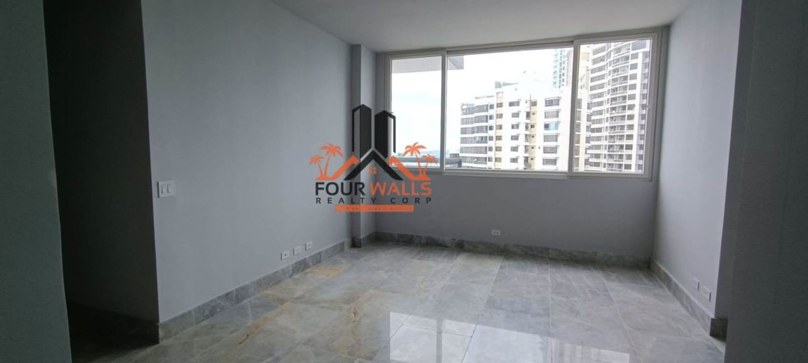 Contemporary kitchen with marble countertop island, modern cabinetry and ocean view at PH The Towers in Punta Paitilla Panama