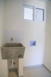 Open concept bright living and dining with large window in rental apartment