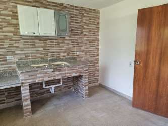 Patterned paved courtyard tropical plants decorative fence Margarita Colón Panama