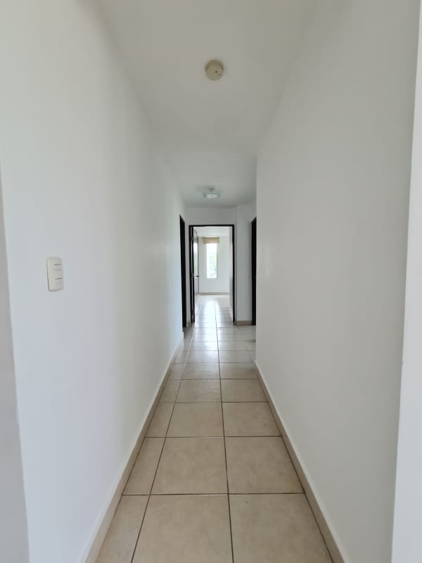 Long interior hallway with tiled floors and doorways Clayton Park Panama apartment
