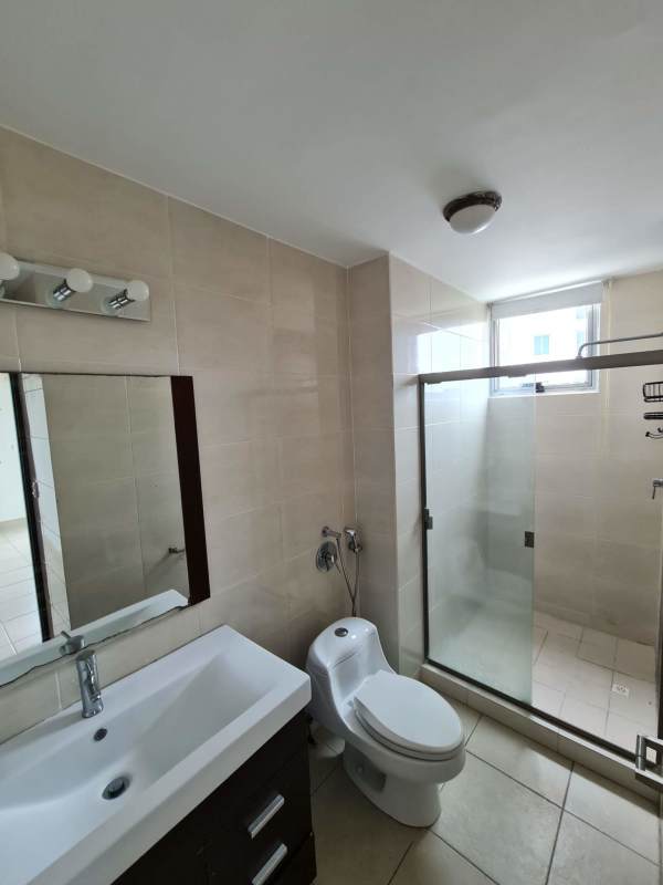 Bathroom with glass shower enclosure, beige tiles, modern fixtures in Clayton Park Panama