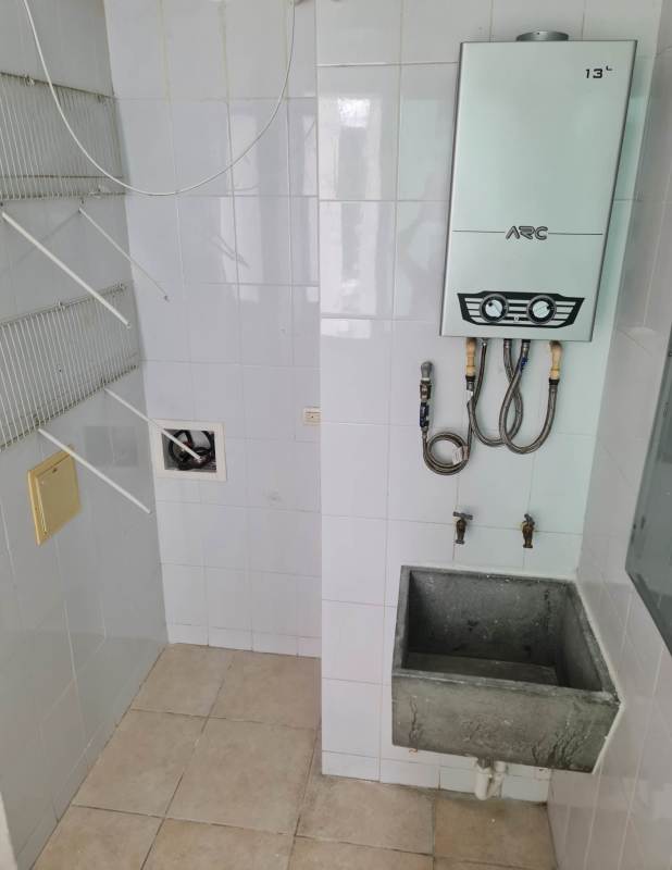 Laundry utility area with water heater, concrete sink Clayton Park apartment Panama