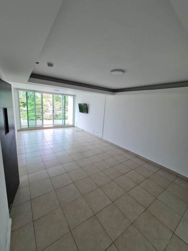 Kitchen with granite countertops, wooden cabinetry, built-in stove, window overlooking gardens at Clayton Park Panama