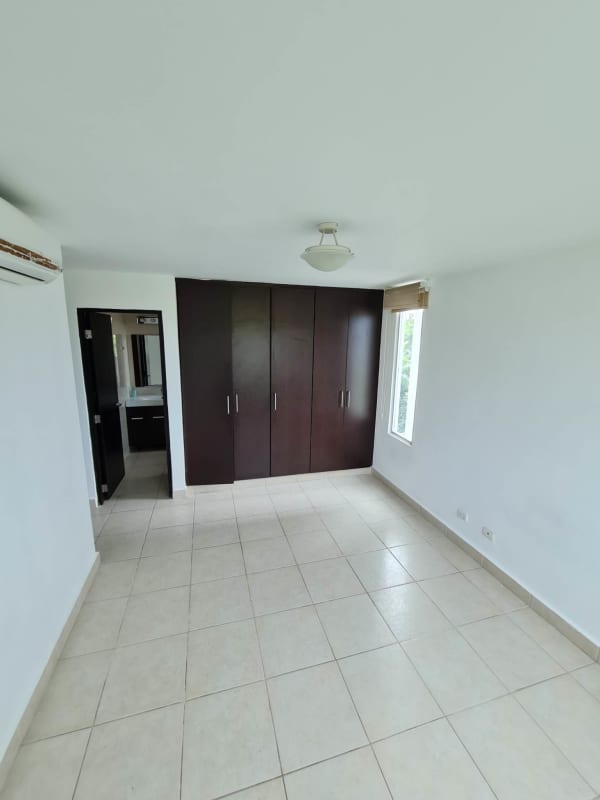 Bright bedroom with large closet, ceramic floors, AC unit in Clayton Park Panama apartment for rent