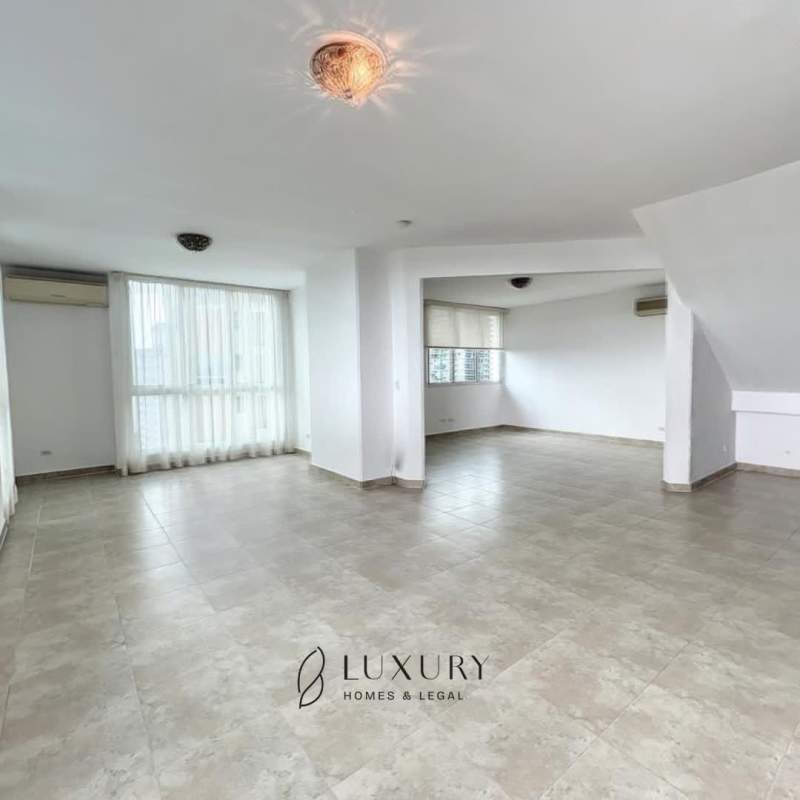 Expansive open-plan living and dining space with large windows at duplex penthouse PH Mystic Point Panama