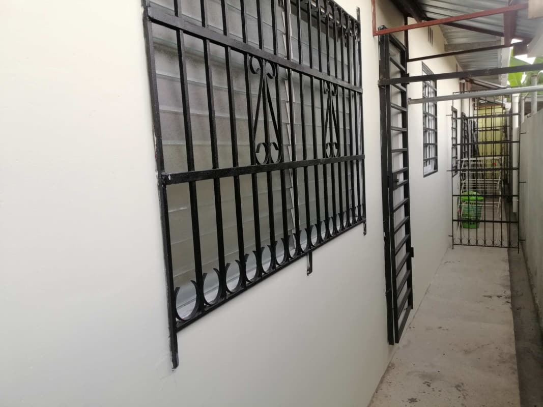 Spacious open living dining space with tile floors and yellow accent wall Villa de Las Acacias Panama City