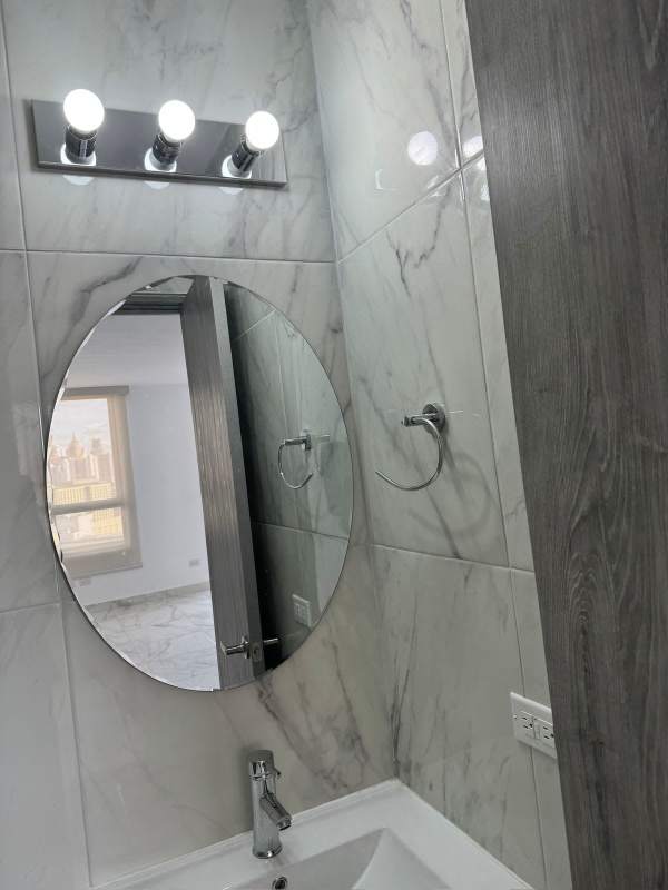 Contemporary bathroom with marble tiles, glass shower at The Gray Panama