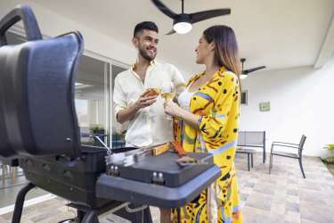 Covered terrace at Paradise Point Coronado beach house with outdoor seating overlooking garden trees