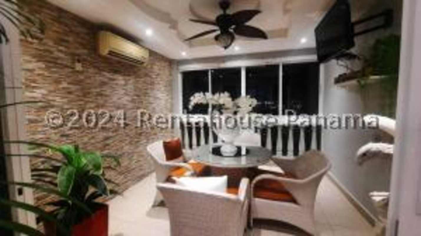 Contemporary dining room with glass table and chandelier in Altos de Panamá home