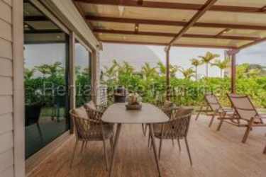 Outdoor patio area with wicker furniture, sea views in Playa Escondida Panama