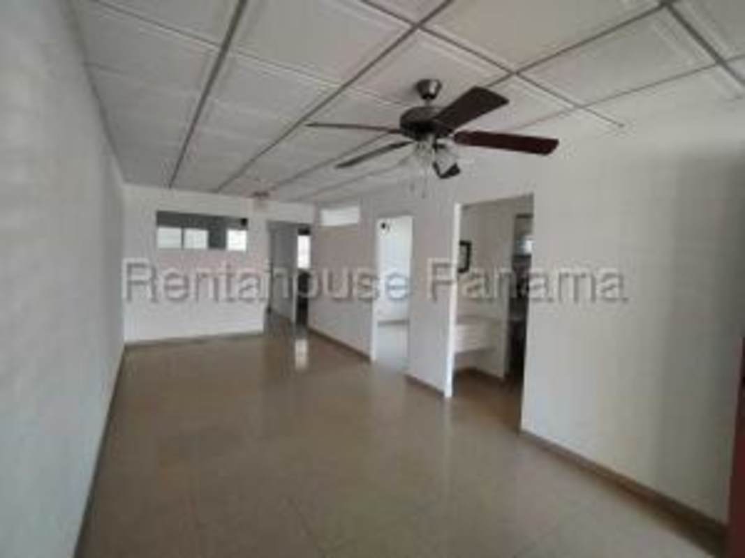 Spacious minimalist kitchen with tile backsplash and ceiling fan at Altos de Santa María