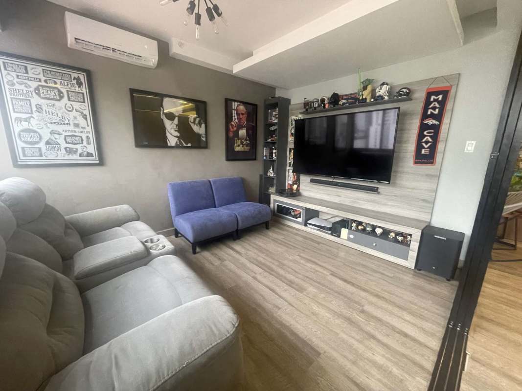 Living and dining room with large windows and balcony access in PH Balboa Bay Panama