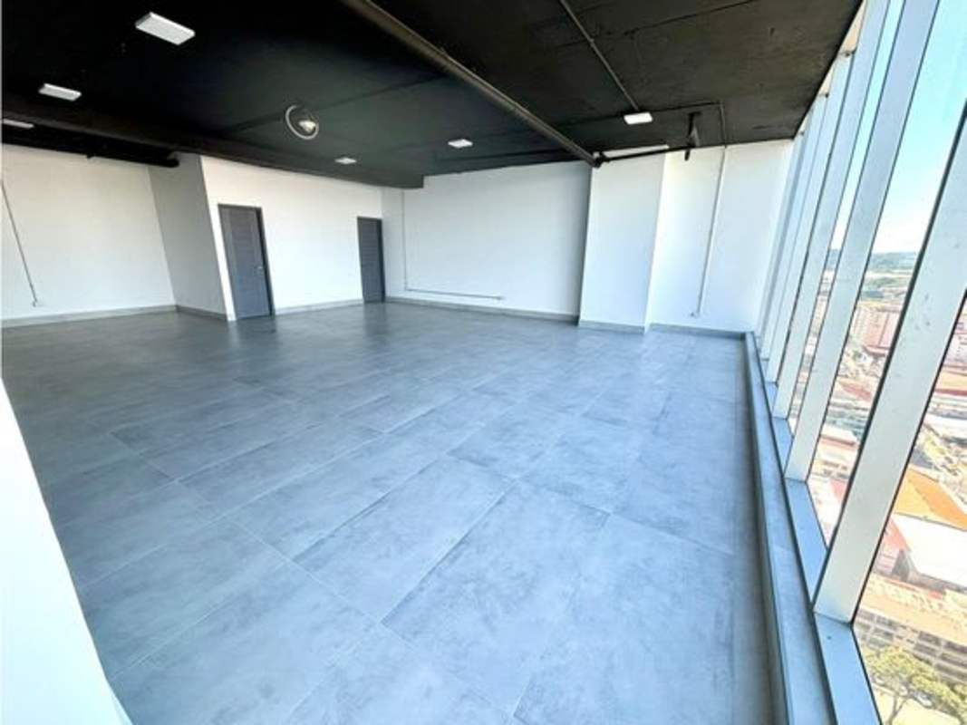 Modern open office for rent with exposed ceiling and city skyline view in PH Balboa Office Center Panama City