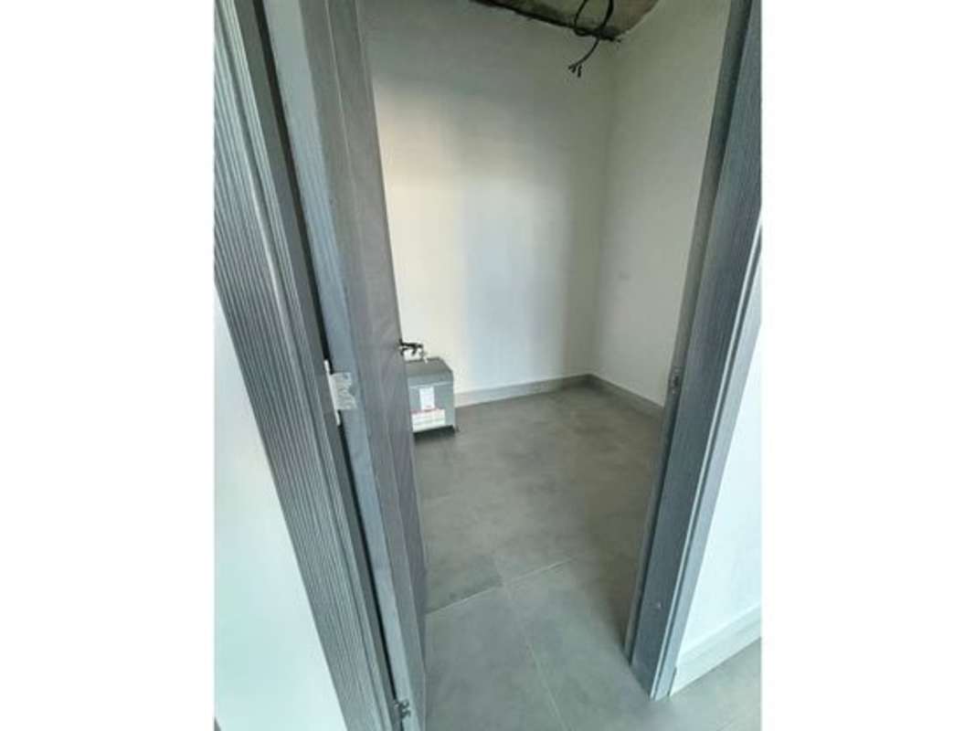 Unfinished service room with gray tiled floor in PH Balboa Office Center Panama City