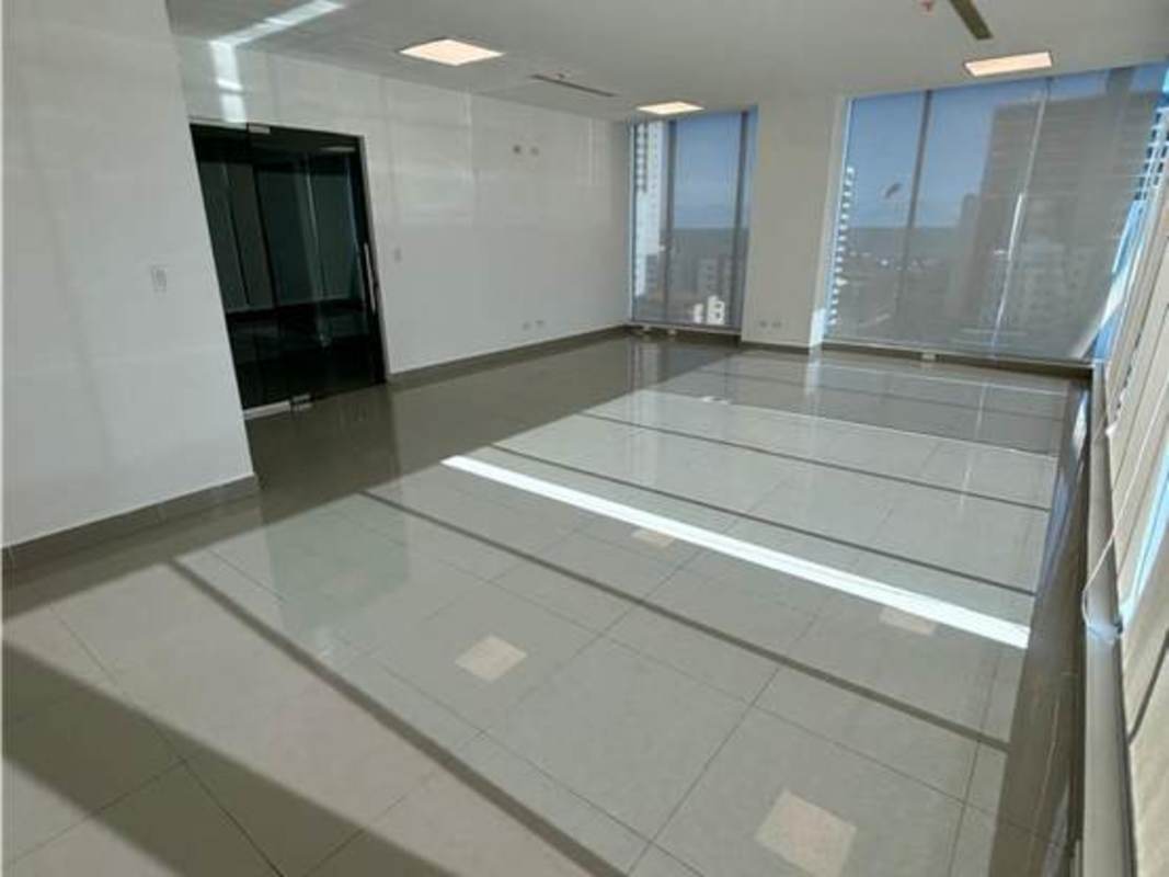 Bright empty office with large windows and tiled floor in PH Office 77 Panama City