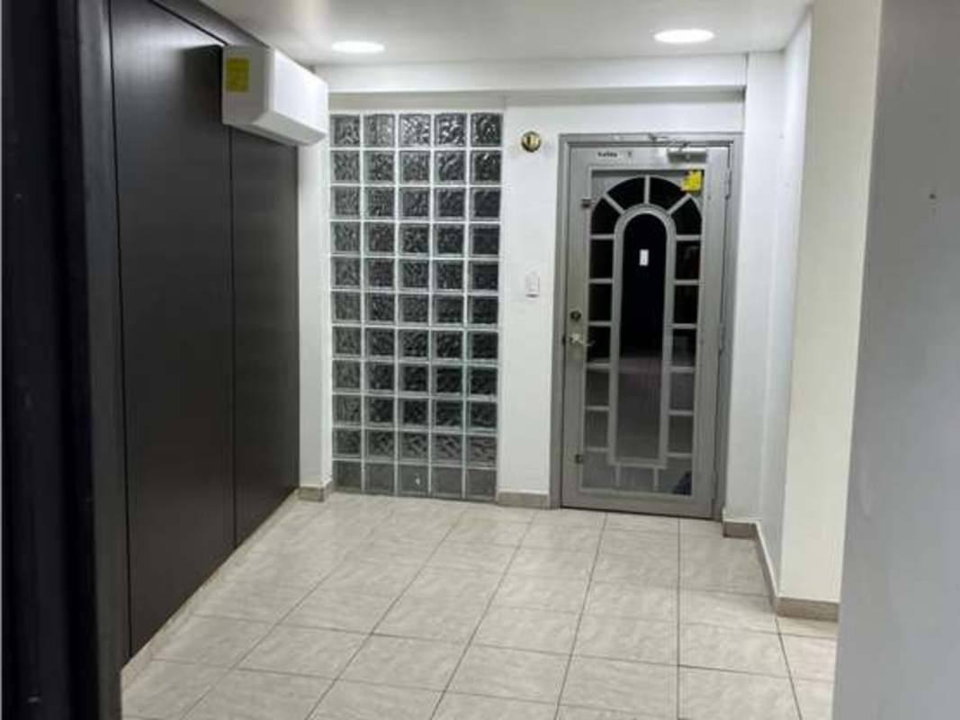 Hallway with elevator, security entry and glass details in San Francisco Business Center Panama