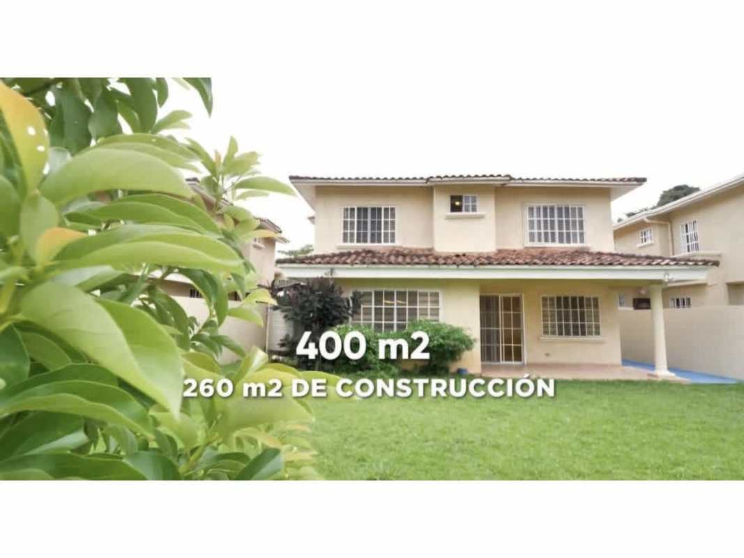 Two-story beige house with tiled roof green lawn PH Albrook Gardens Panama