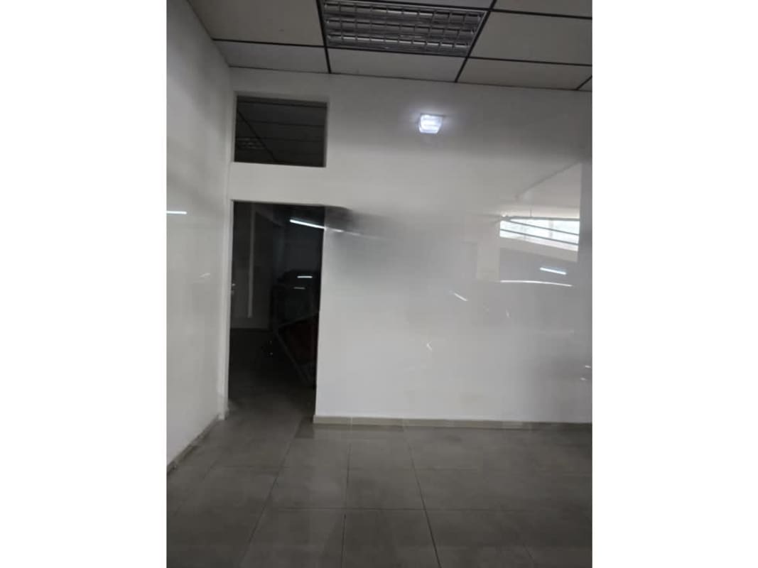 Entrance area with tiled floor and fluorescent lighting inside Balboa Plaza commercial unit Panama City